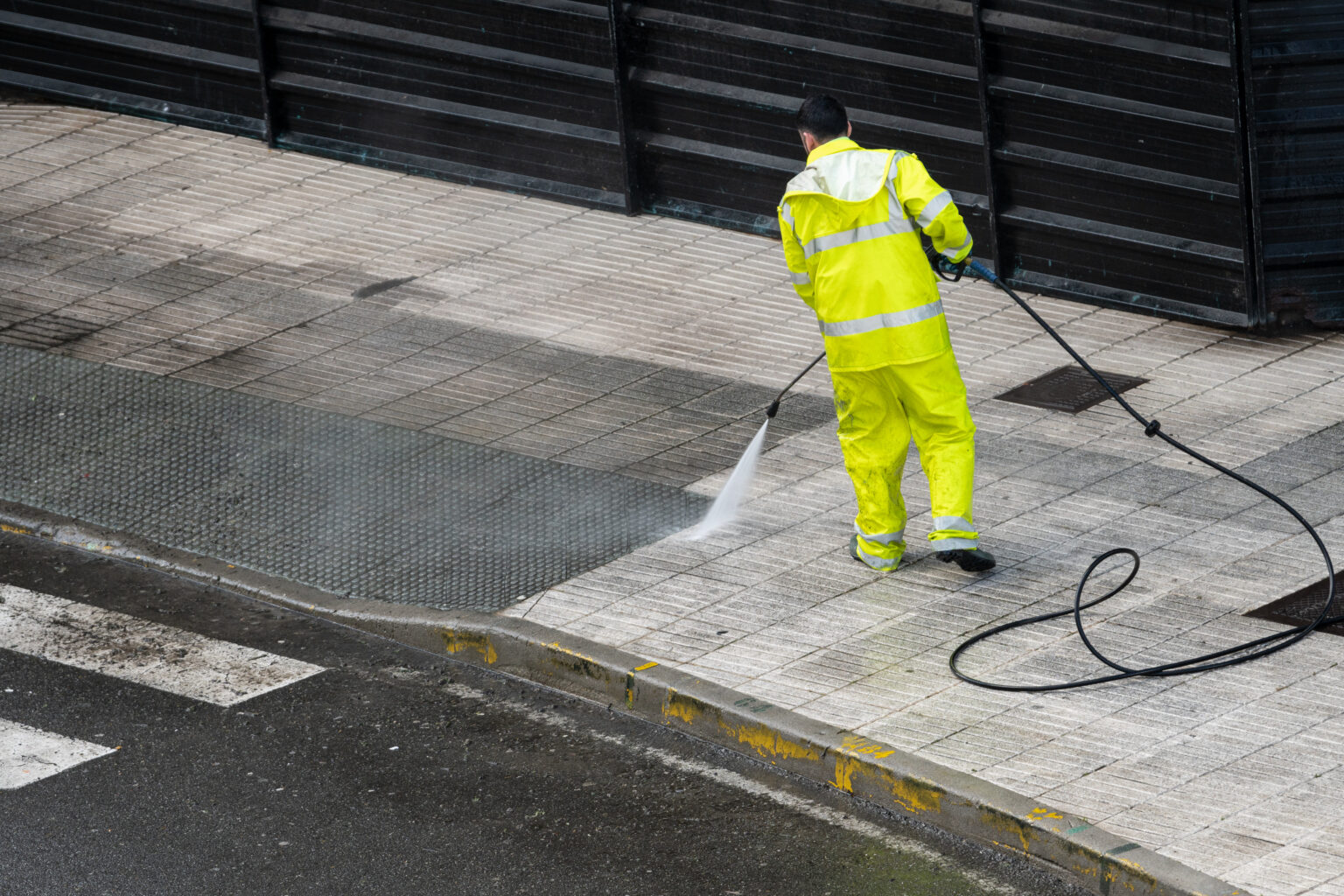 Professional pressure washing service cleaning a sidewalk in [Your Service Locations: Virginia Beach, Norfolk, Chesapeake, Portsmouth, Suffolk to maintain a spotless and damage-free exterior.